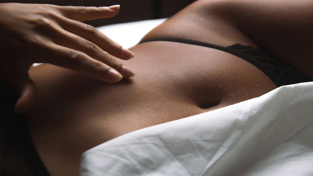 a close up of a person laying on a bed