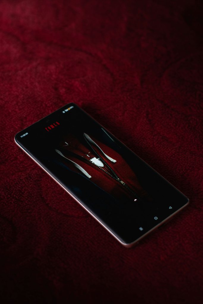 A cell phone sitting on top of a red surface